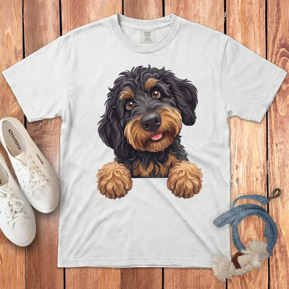 White t-shirt with black and tan doodle dog graphic, Superga shoes, and rope toy.