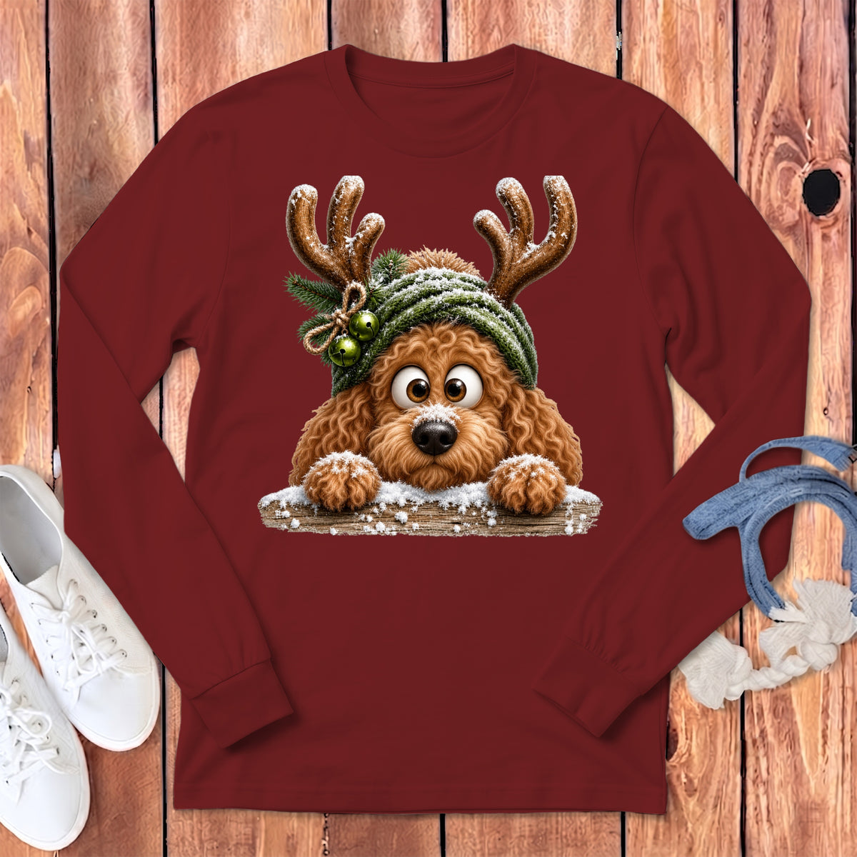 Maroon long-sleeve shirt with a cartoon dog wearing reindeer antlers and a knitted hat.