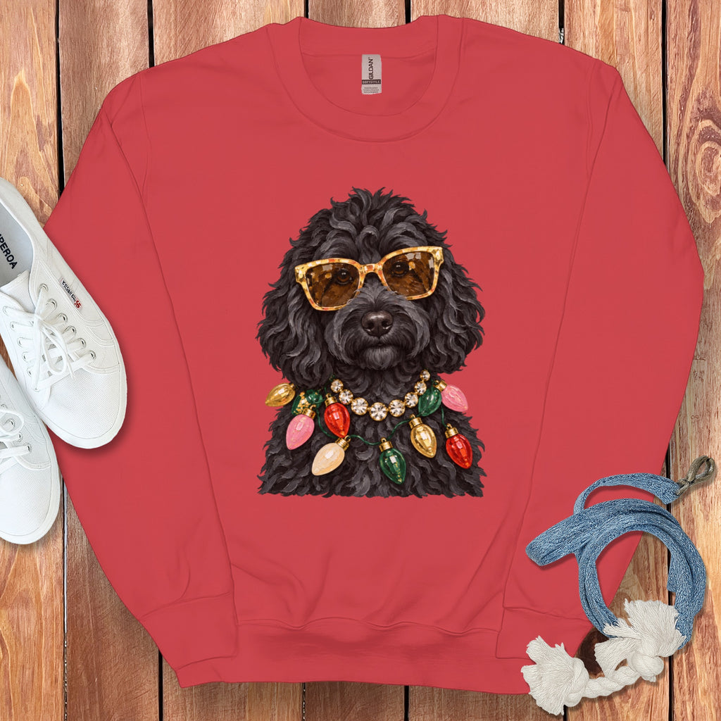 Black poodle wearing sunglasses and a Christmas light necklace.