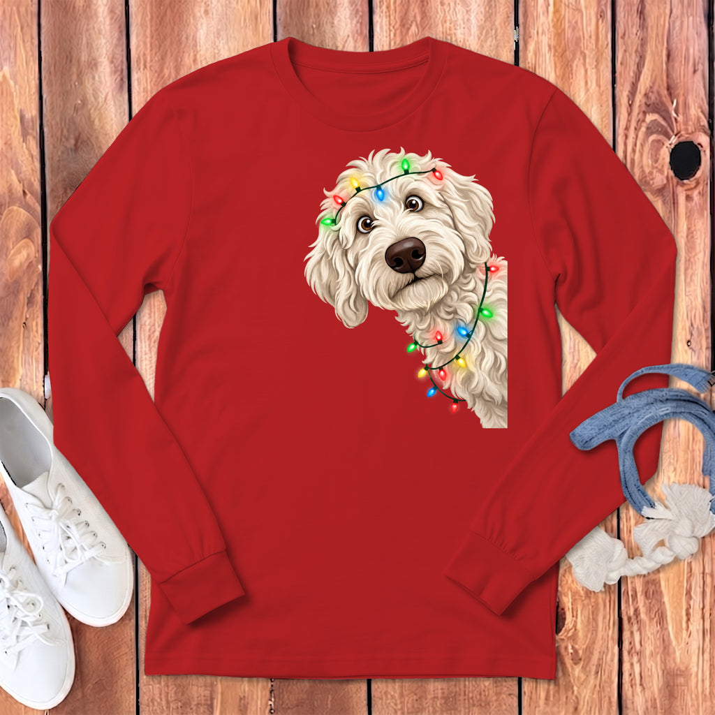 Red long-sleeve shirt with a white doodle dog wearing colorful Christmas lights.