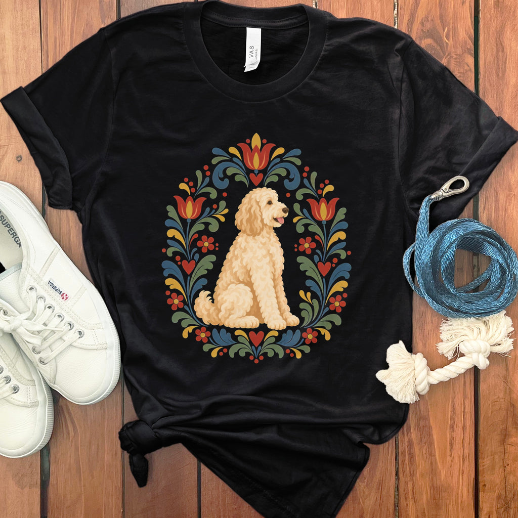 Black t-shirt with a cream-colored doodle dog inside a folk art floral wreath.