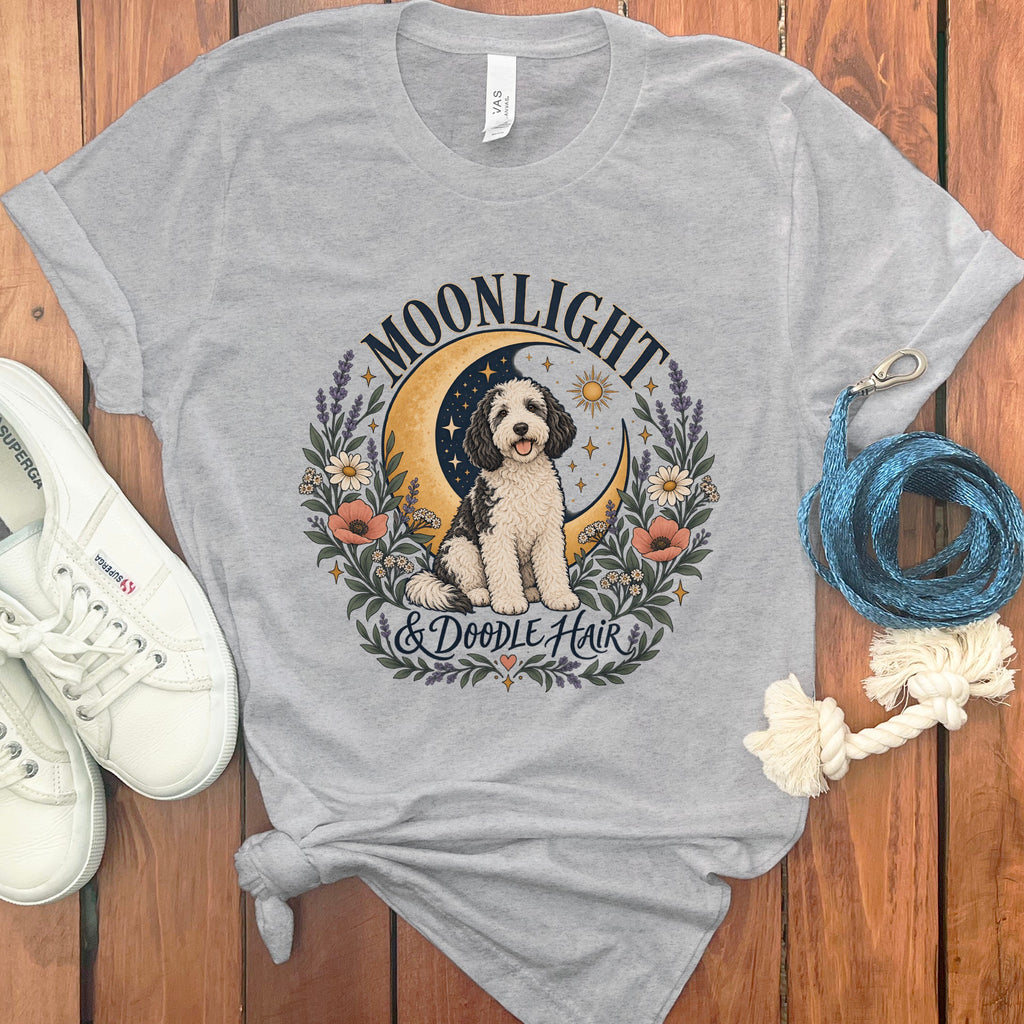 Gray t-shirt with a doodle dog on a crescent moon, floral wreath, and text.
