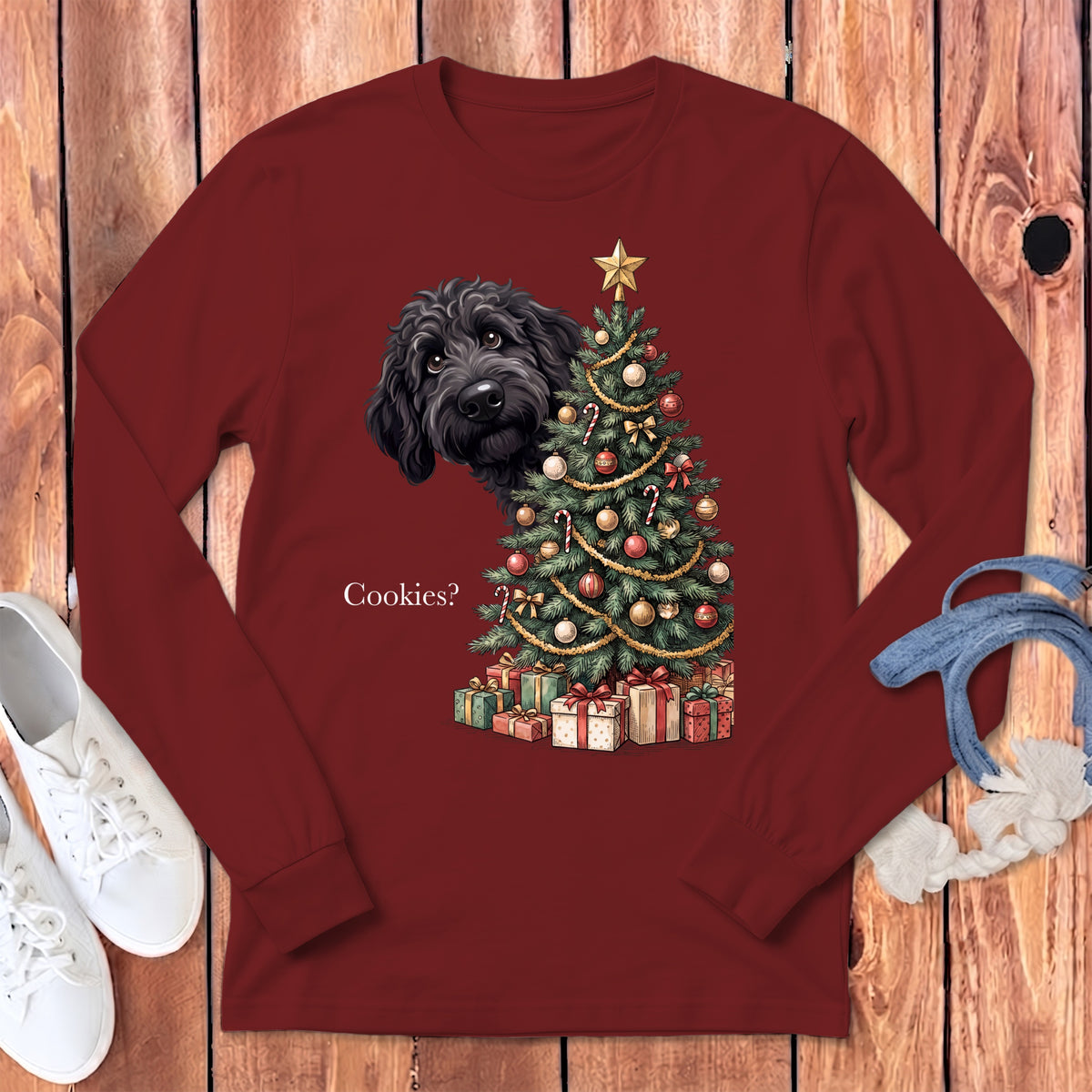 Black dog peeking at a Christmas tree with presents and text "Cookies?".