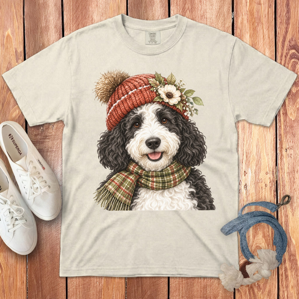 T-shirt with a fluffy dog wearing a knit hat and plaid scarf illustration.