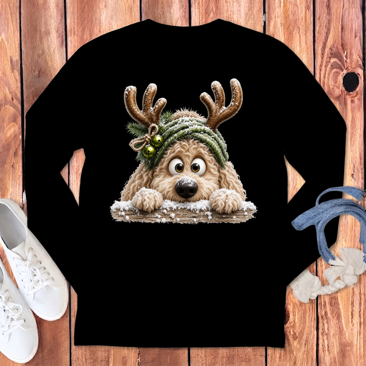 Fluffy dog wearing reindeer antlers and a green knitted hat with bells.