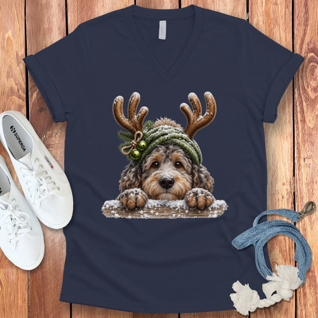 Labradoodle dog wearing reindeer antlers and a winter hat, front graphic on navy t-shirt.