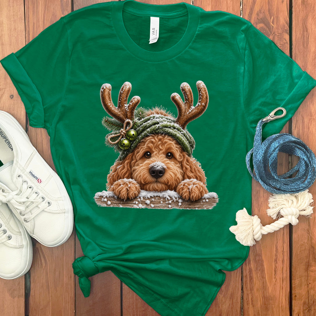 Green t-shirt with doodle dog wearing antlers and a knitted hat.