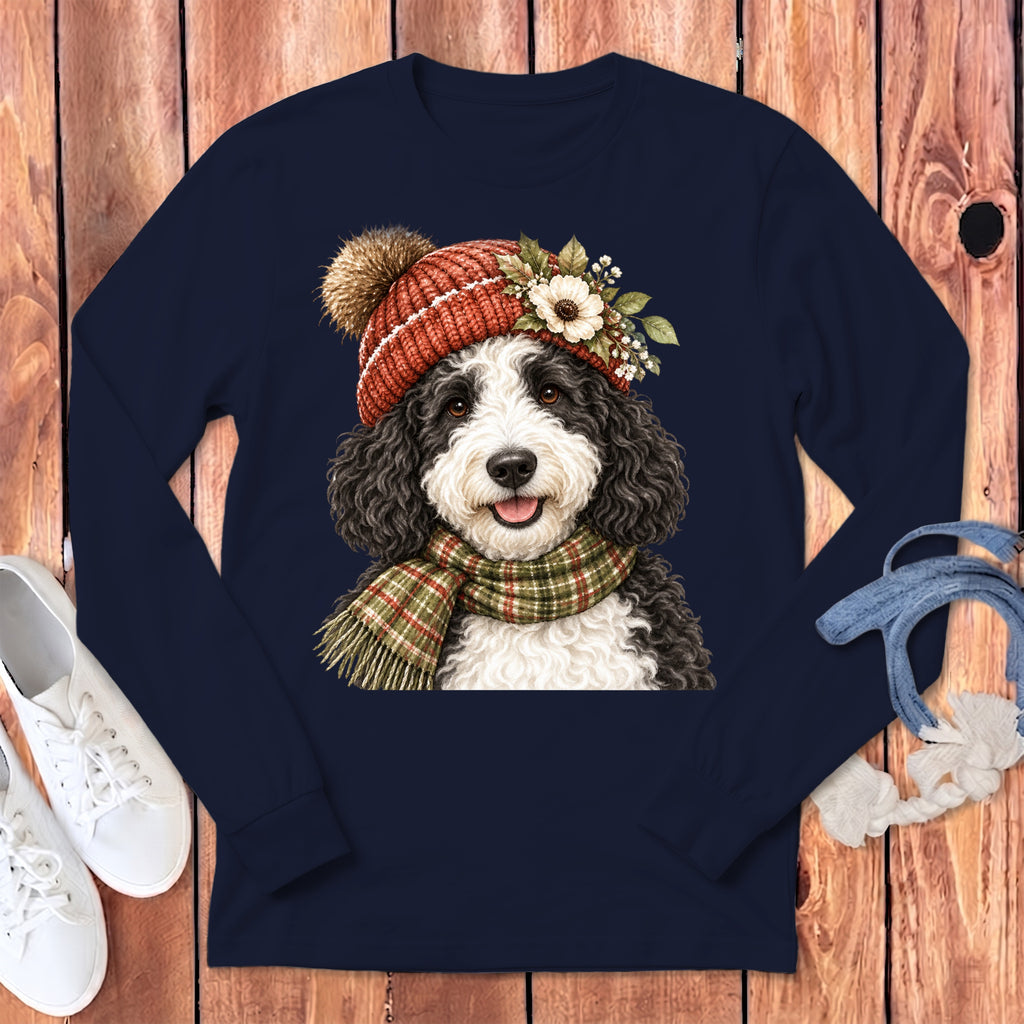 Black and white dog wearing a beanie and scarf, printed on a navy shirt.
