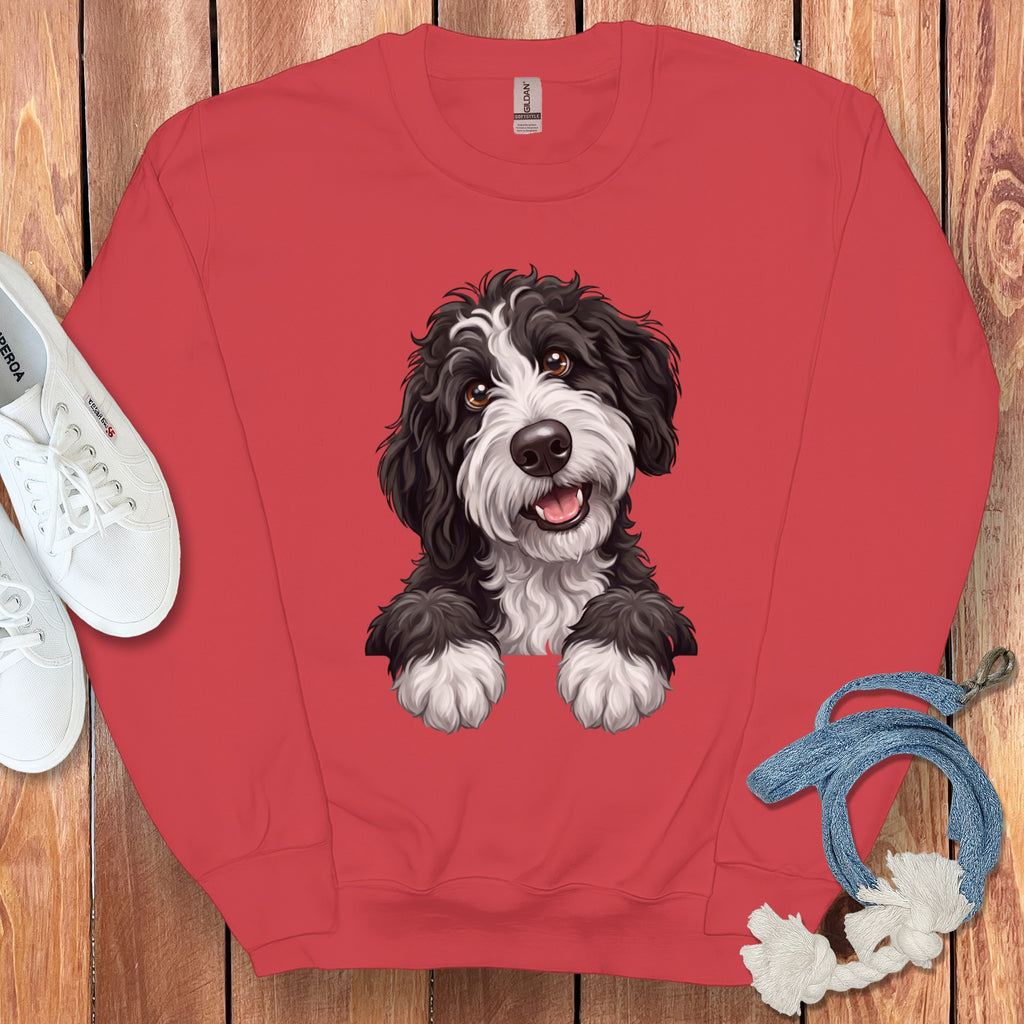 Red sweatshirt with a cartoon black and white dog illustration and white sneakers.