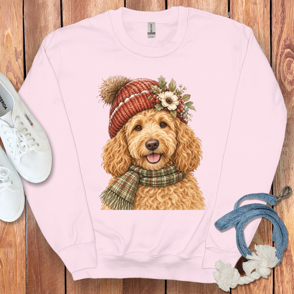Pink sweatshirt with watercolor of a golden doodle wearing a beanie and scarf.