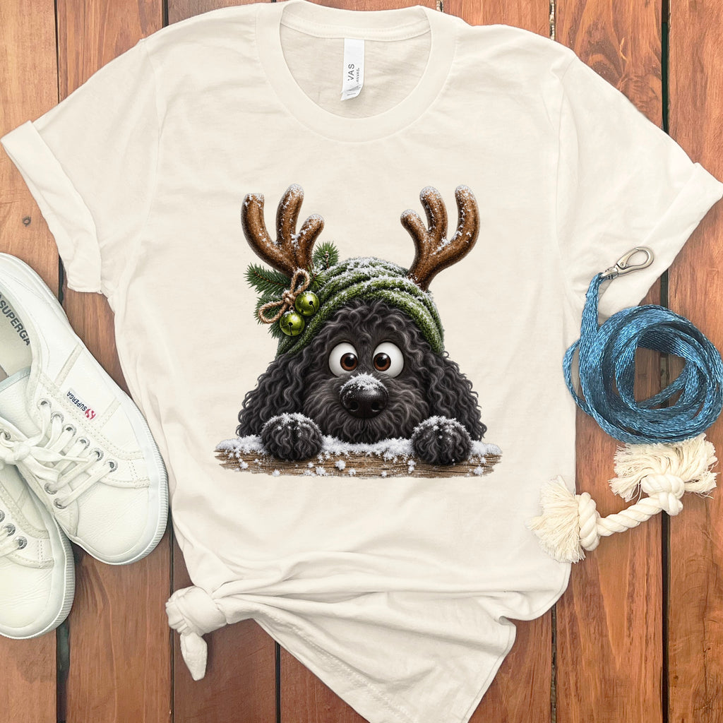 Cream t-shirt featuring a black dog wearing reindeer antlers and a green beanie.