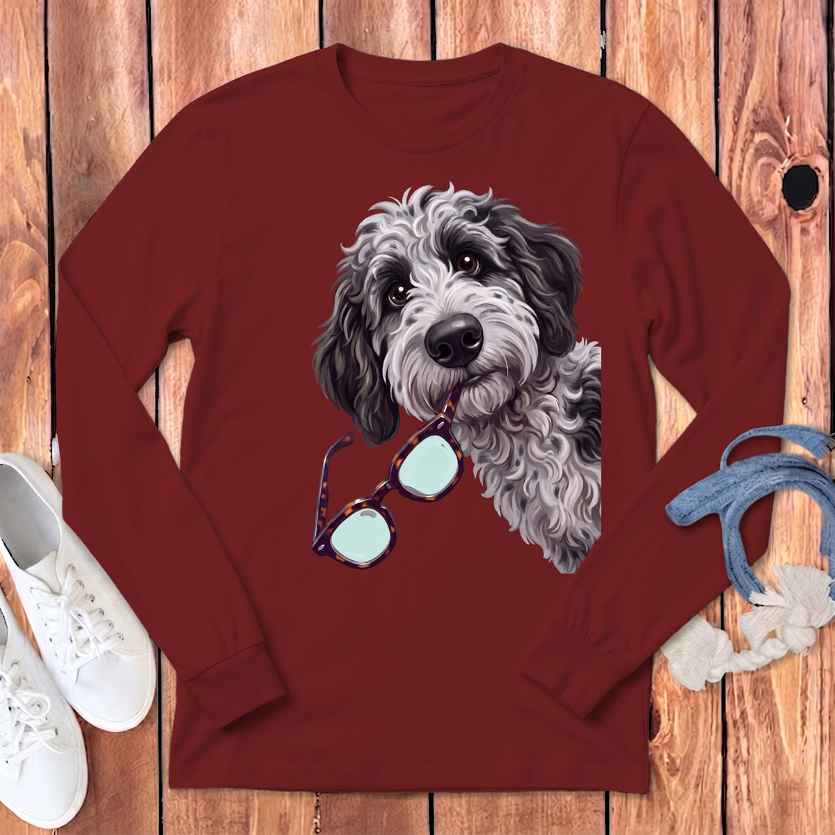 Dark red long-sleeve t-shirt featuring a black and white doodle dog holding glasses.