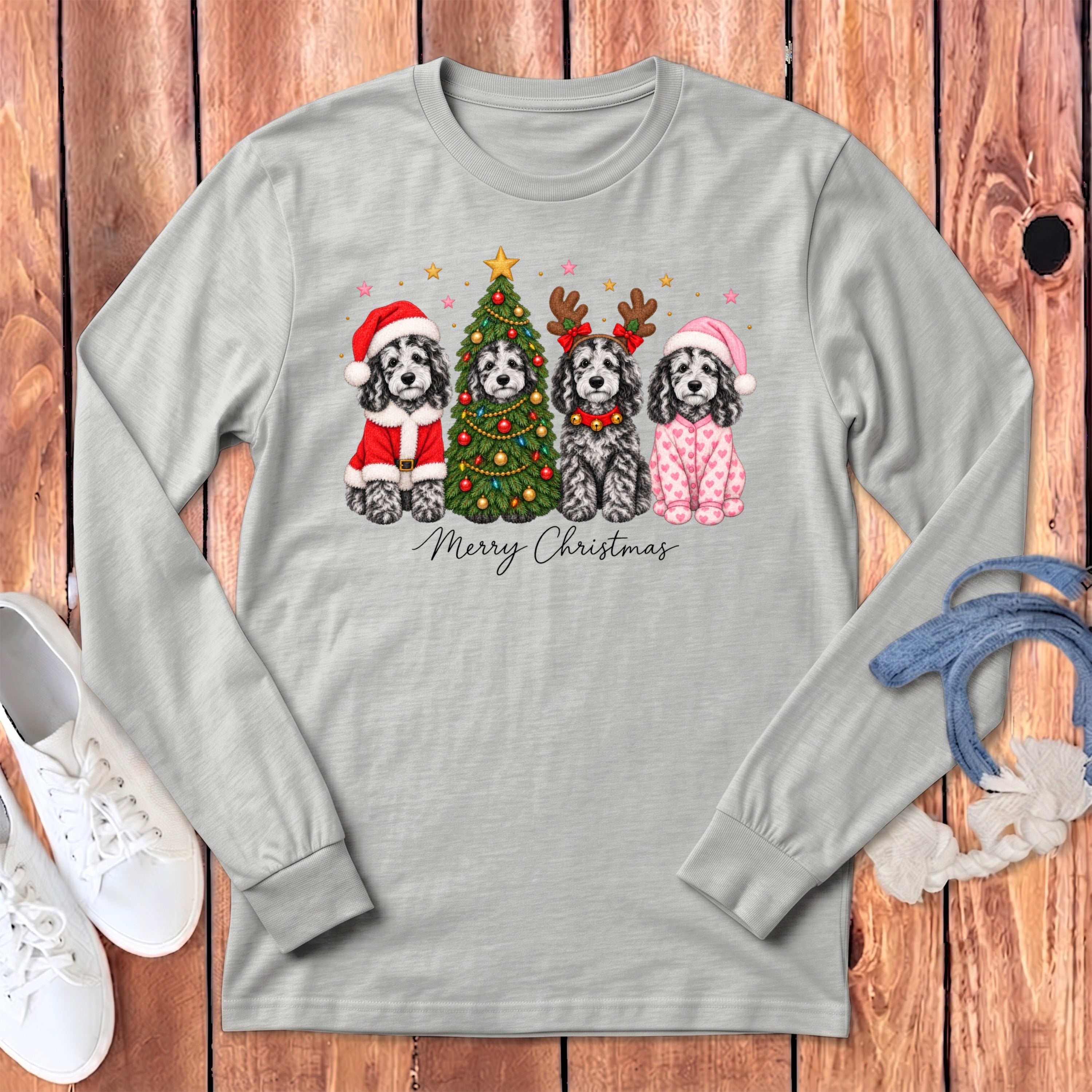 Gray long-sleeve t-shirt featuring four black and white dogs with Christmas accessories and the text Merry Christmas.