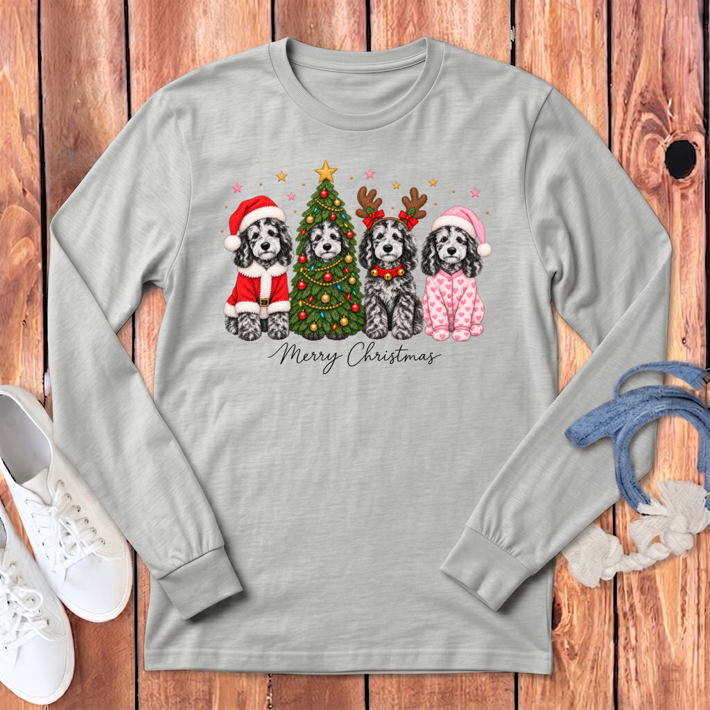 Gray long-sleeve t-shirt featuring four black and white dogs with Christmas accessories and the text Merry Christmas.