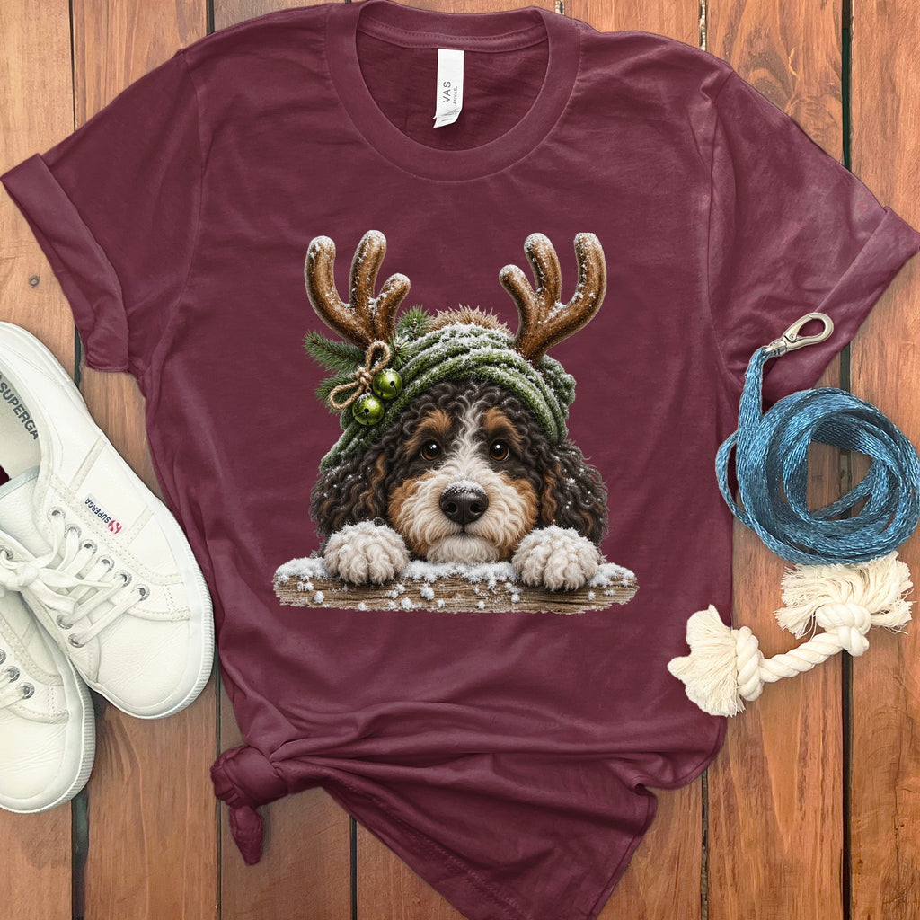 Maroon t-shirt with holiday dog graphic and white sneakers.