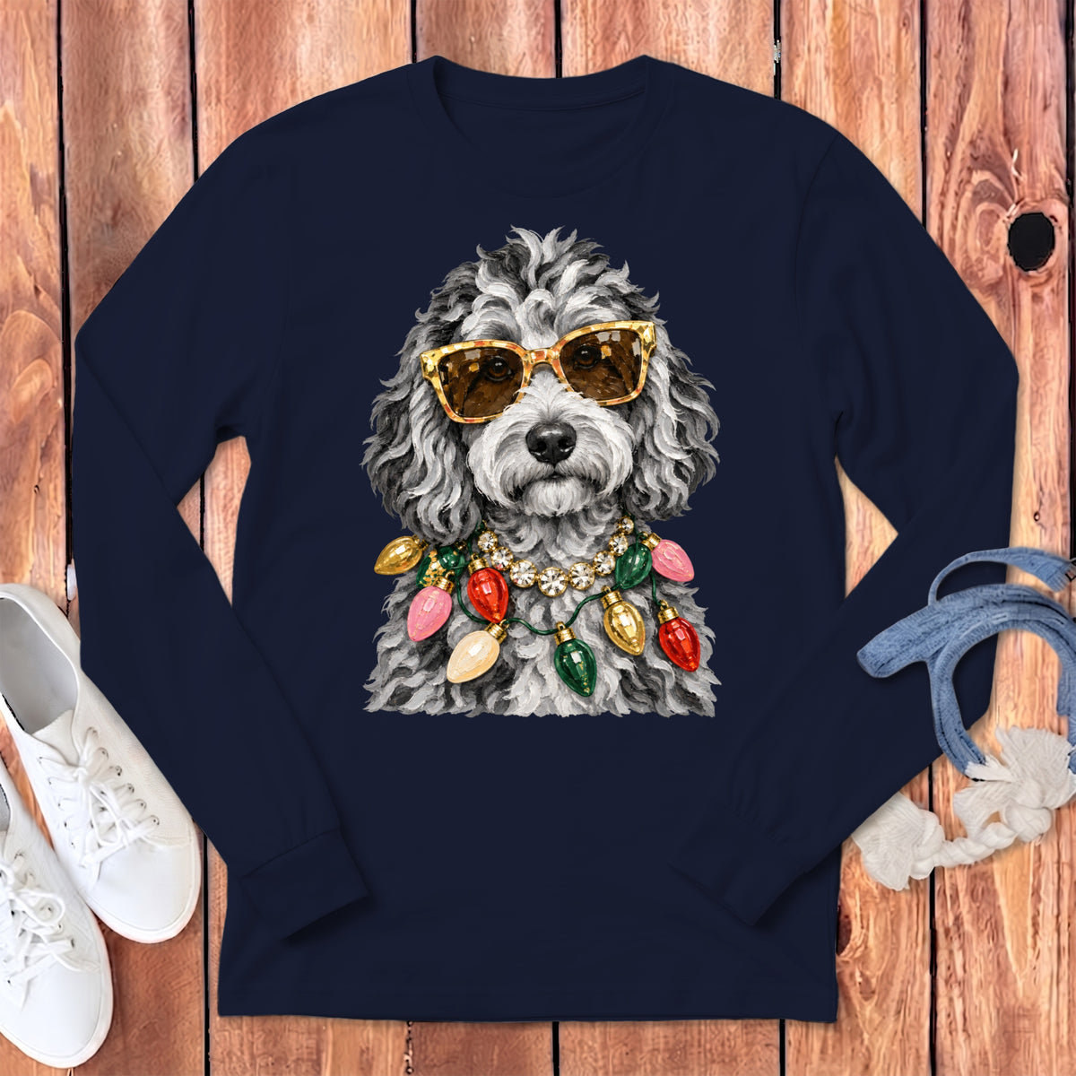 Dog with sunglasses and Christmas lights garland on navy shirt.