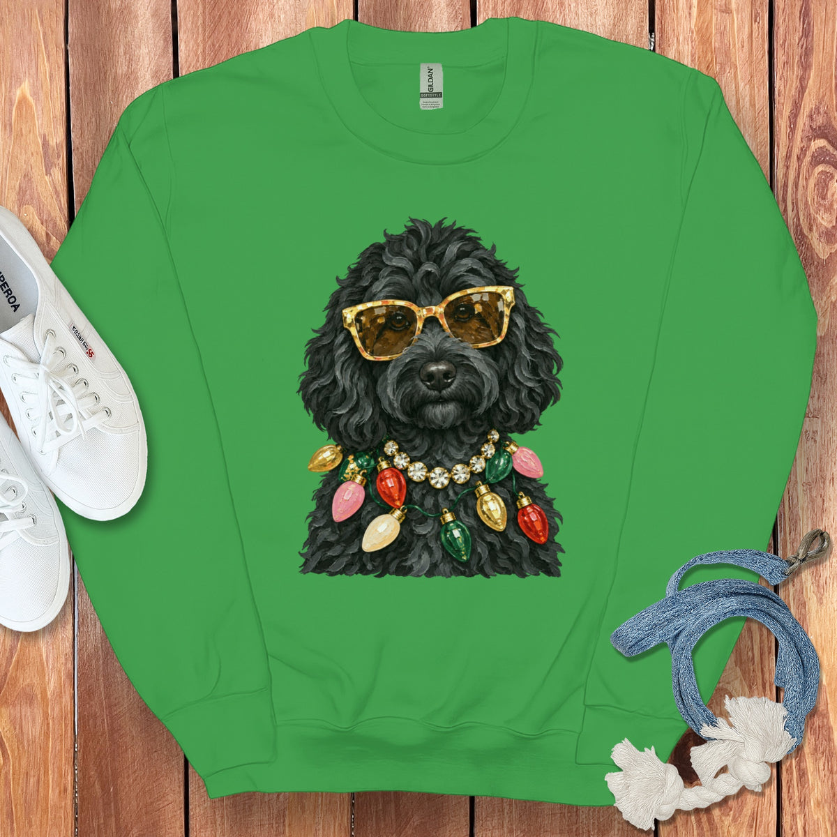 Green crewneck sweatshirt with a black dog wearing sunglasses and Christmas lights.