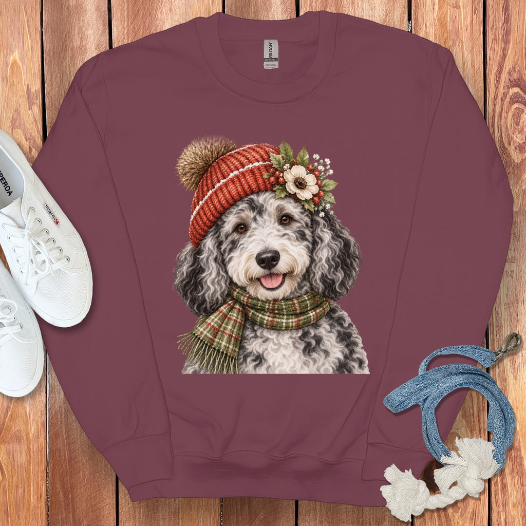 Maroon sweatshirt with a watercolor doodle wearing a winter hat and scarf.