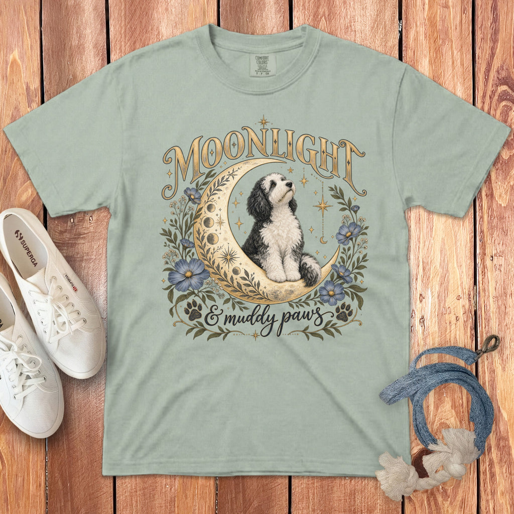 Light green t-shirt featuring a graphic of a dog sitting on a crescent moon with flowers and text.