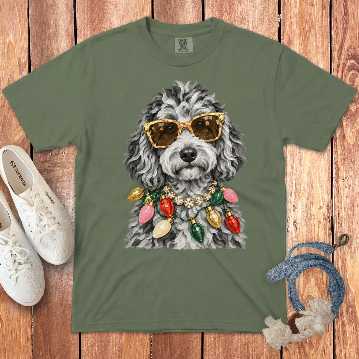 Green t-shirt with a doodle dog wearing sunglasses and holiday lights.