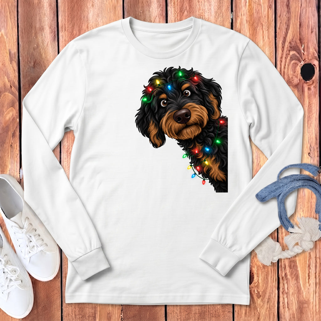 White long-sleeve shirt with a black and tan dog wearing colorful Christmas lights.