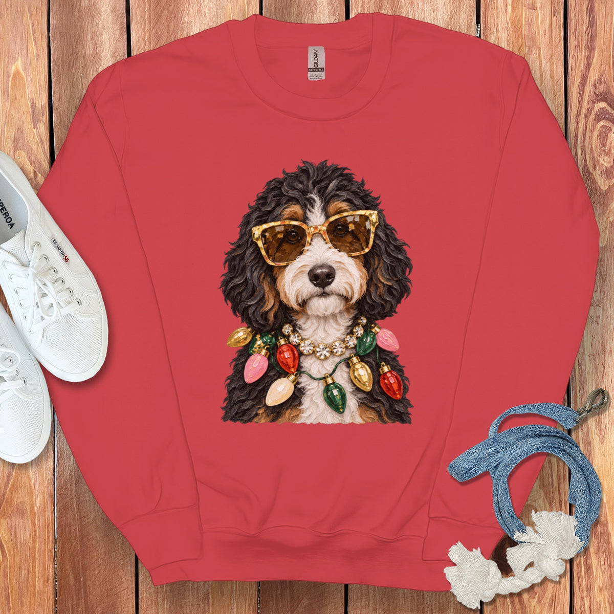 Red sweatshirt with a Bernese Mountain Dog wearing sunglasses and Christmas lights.