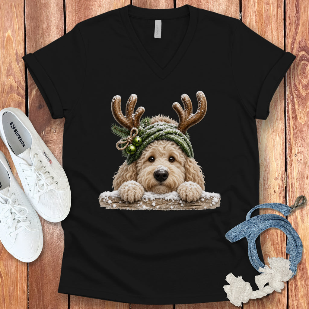 Black v-neck shirt with a golden doodle wearing antlers and a green beanie.