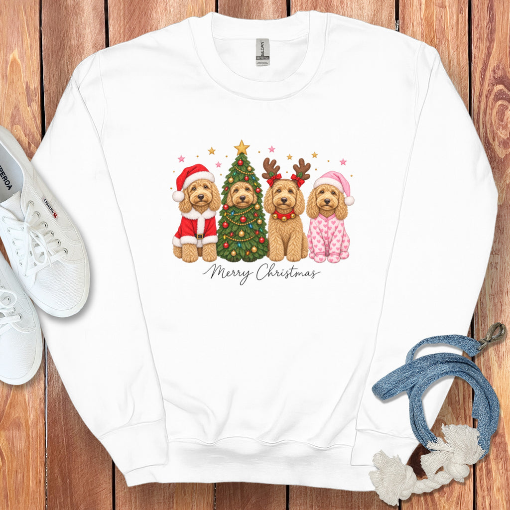A white crewneck sweatshirt features an illustrated graphic of four dogs dressed in holiday attire flanking a Christmas tree, with the text "Merry Christmas" below.