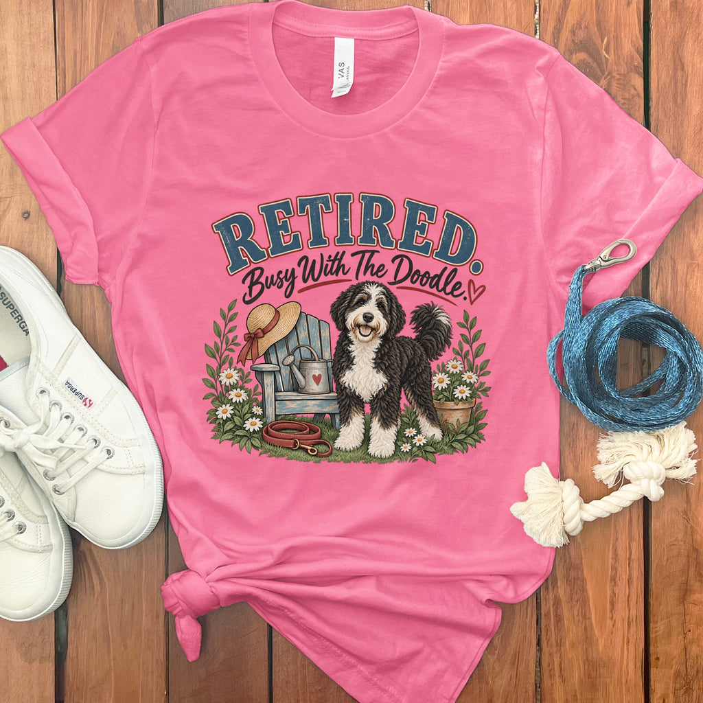 Pink t-shirt with "Retired Busy With The Doodle" text and dog graphic.