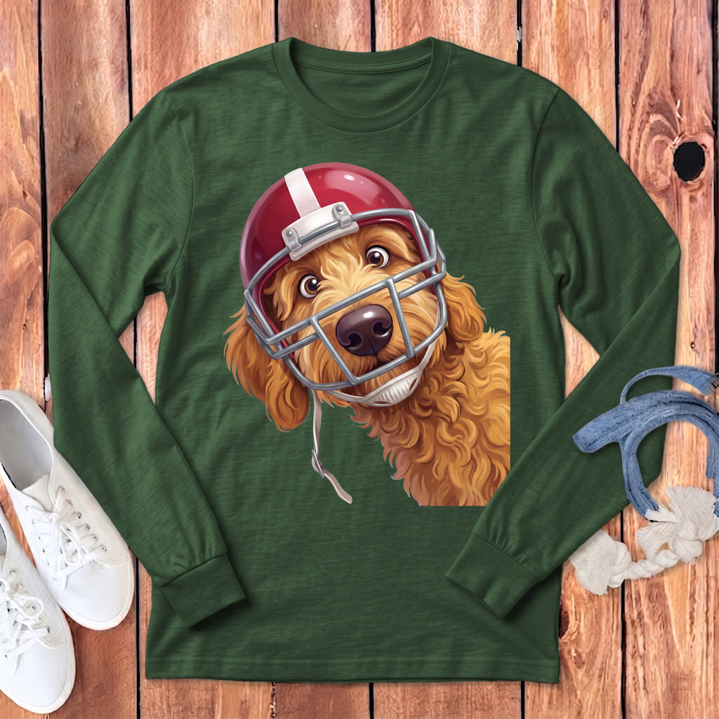 Golden doodle wearing a red and white football helmet on a green long-sleeved shirt.