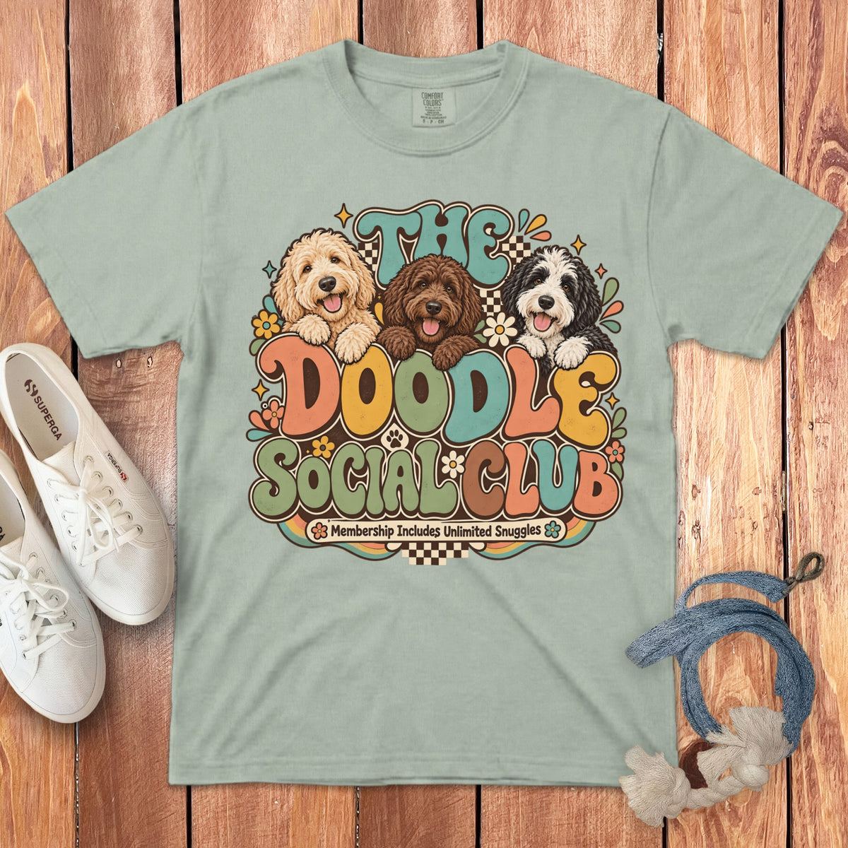 Light green t-shirt with "The Doodle Social Club" graphic and three doodle dogs.