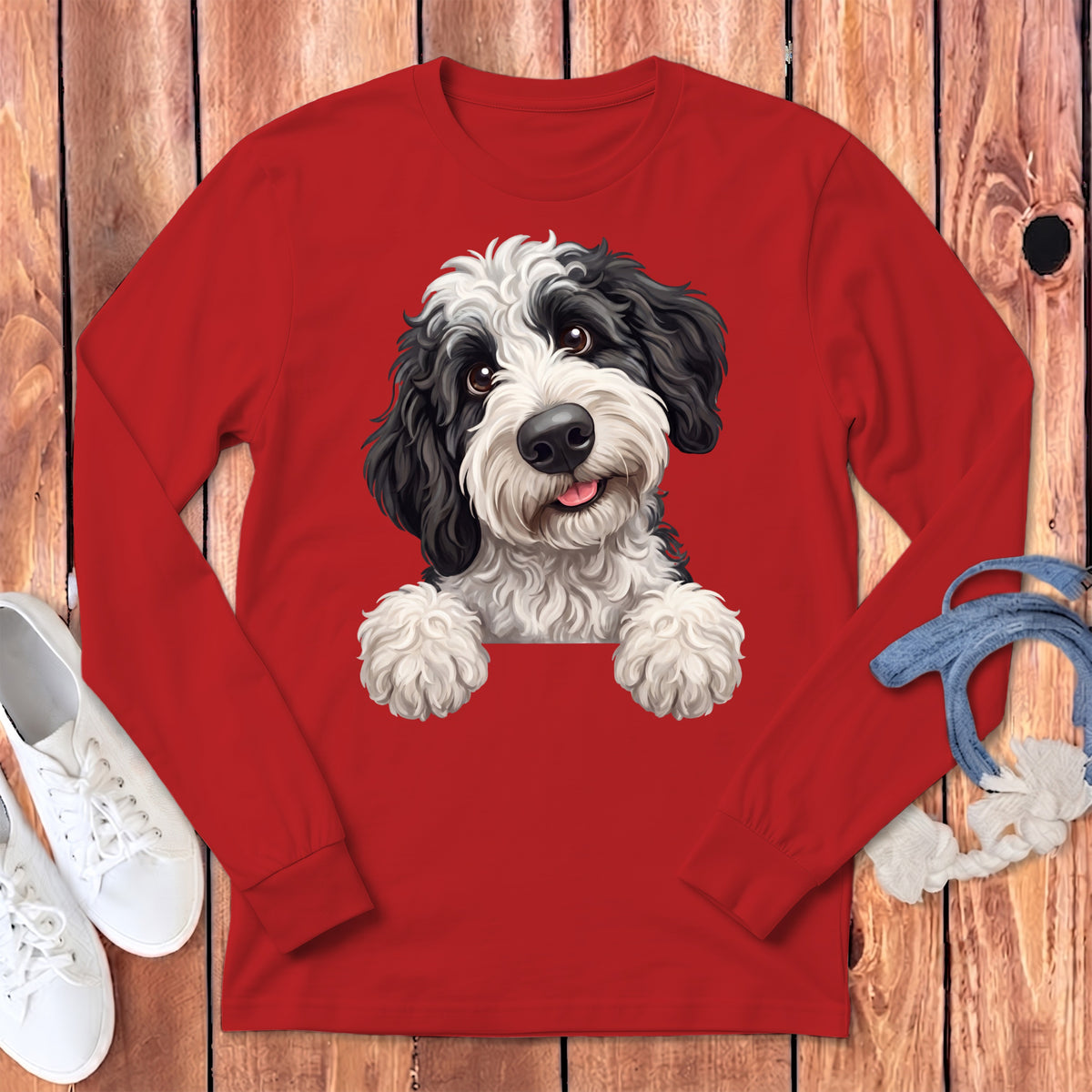 Red long-sleeve shirt featuring a black and white doodle-style dog.