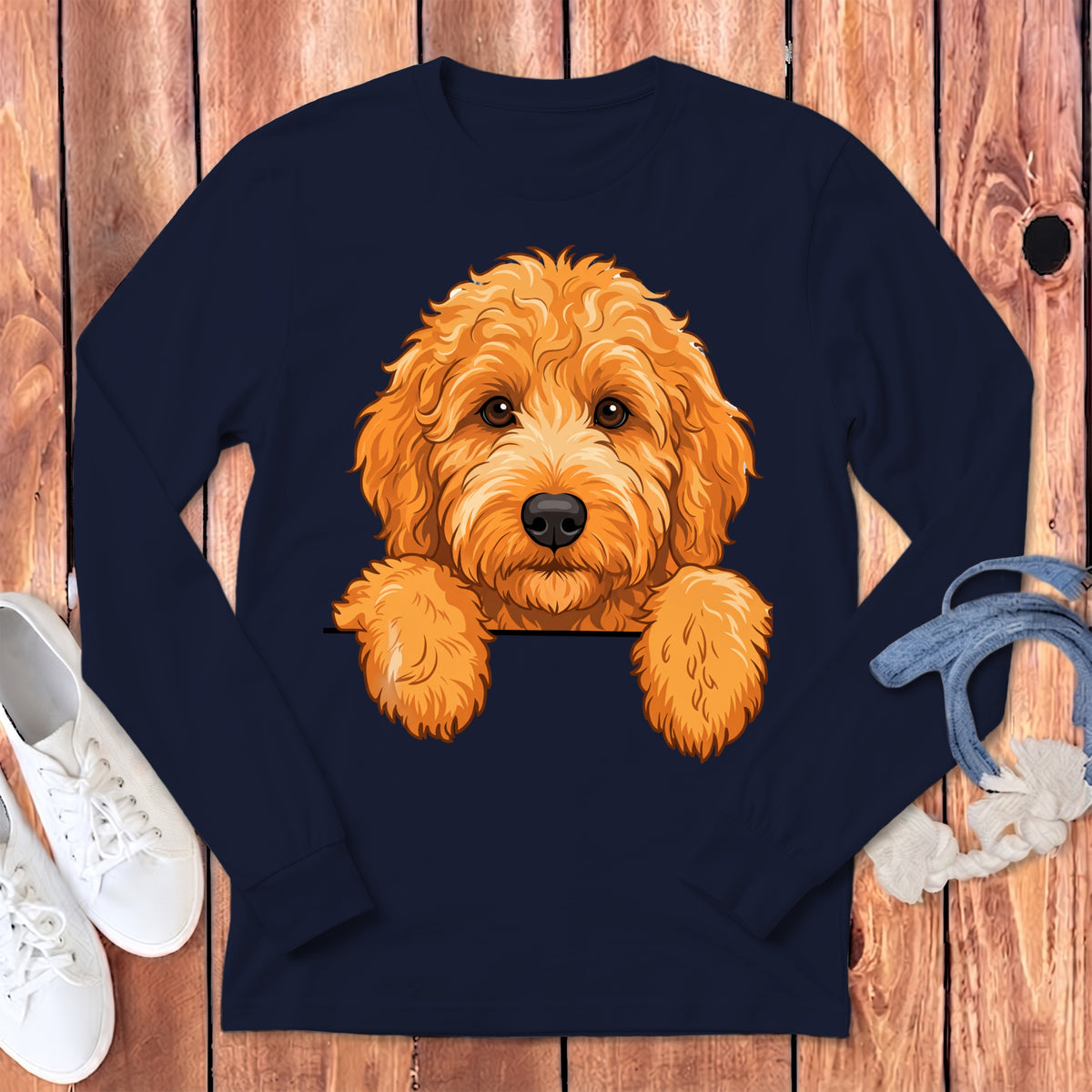 Navy long-sleeve shirt with an orange doodle dog illustration peeking over the collar.