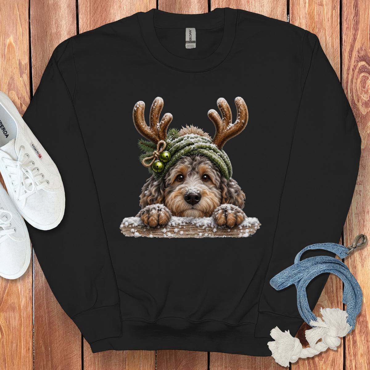 Black sweatshirt with a printed image of a fluffy dog wearing reindeer antlers and a hat.