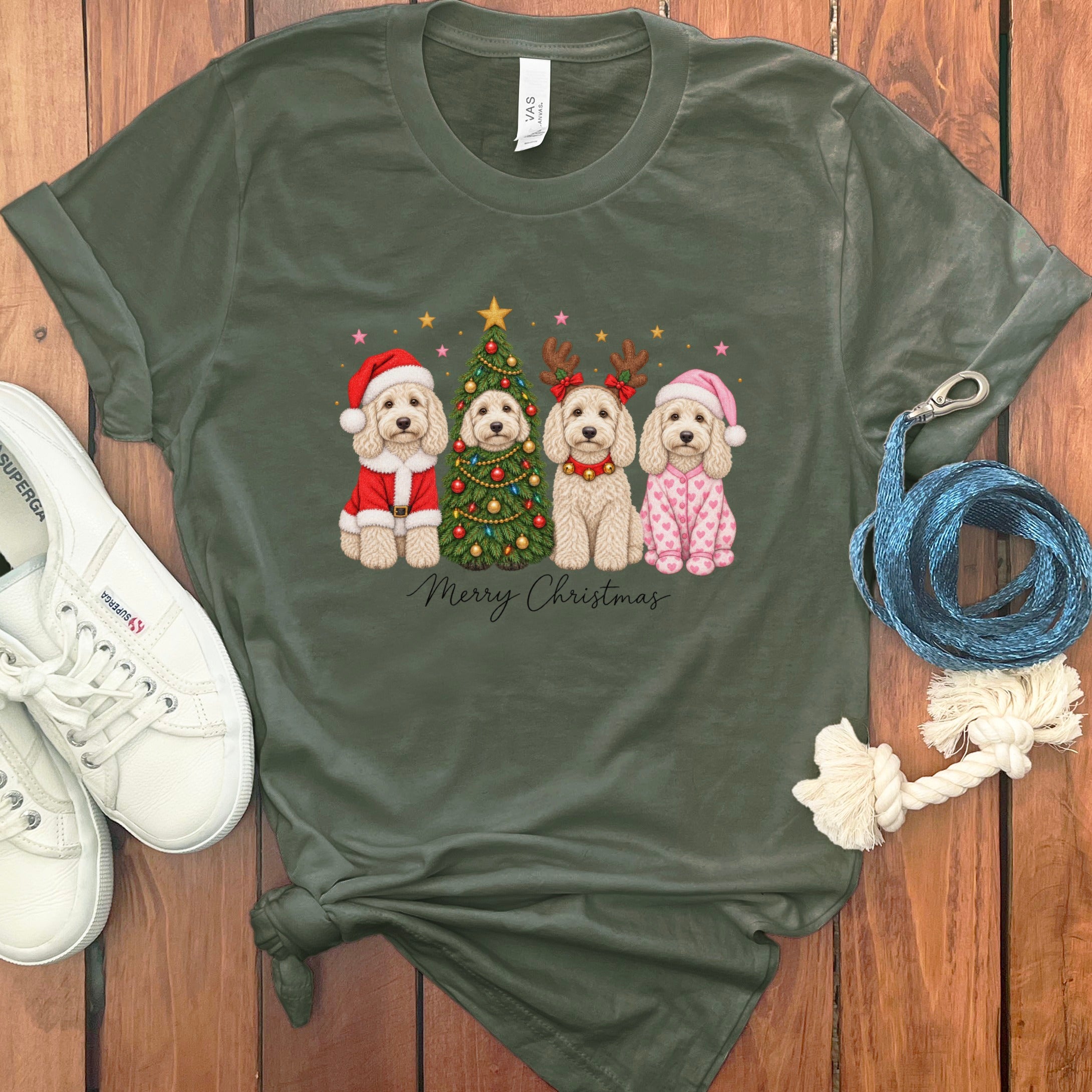 Dark green t-shirt featuring four cartoon dogs dressed for Christmas, white sneakers, and a blue leash.