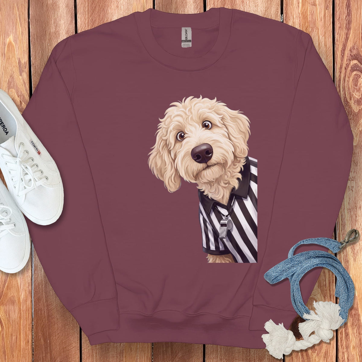 Maroon sweatshirt with a golden doodle wearing a referee shirt and whistle.