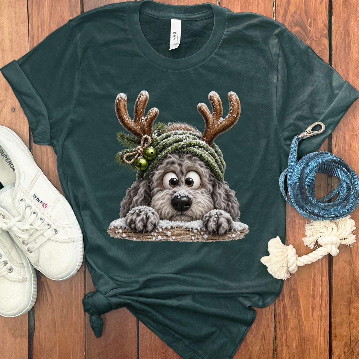 Green t-shirt with a cartoon dog wearing reindeer antlers and a winter hat.