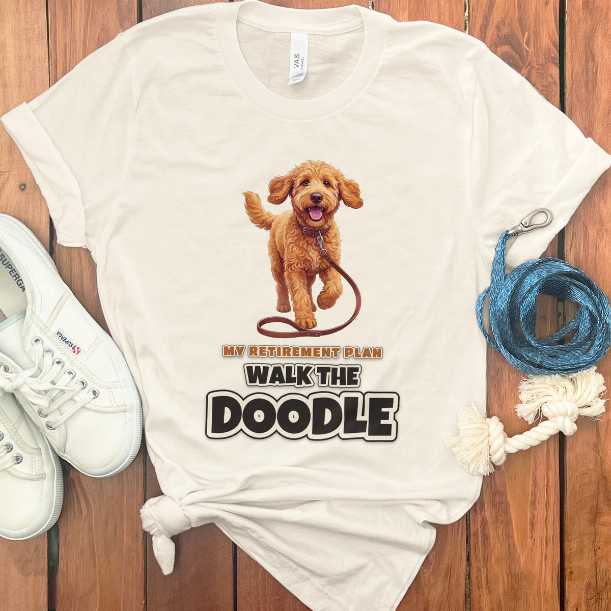 Cream t-shirt with a brown doodle dog graphic and text "MY RETIREMENT PLAN WALK THE DOODLE".