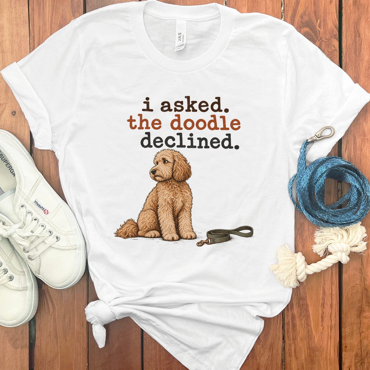 White t-shirt with brown text "i asked. the doodle declined." and a doodle dog.