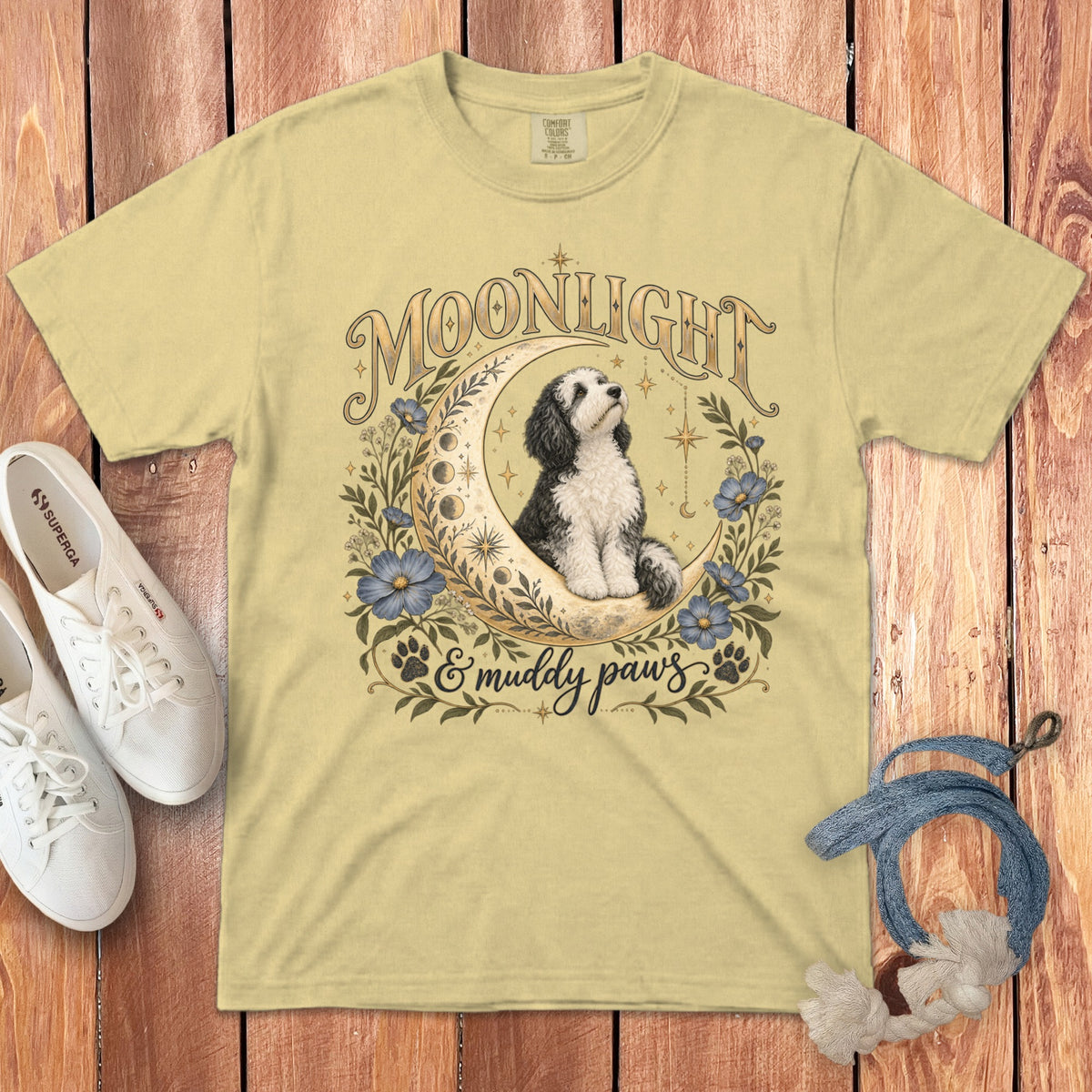 Yellow crewneck t-shirt featuring a graphic of a dog sitting on a crescent moon with flowers, stars, and text.