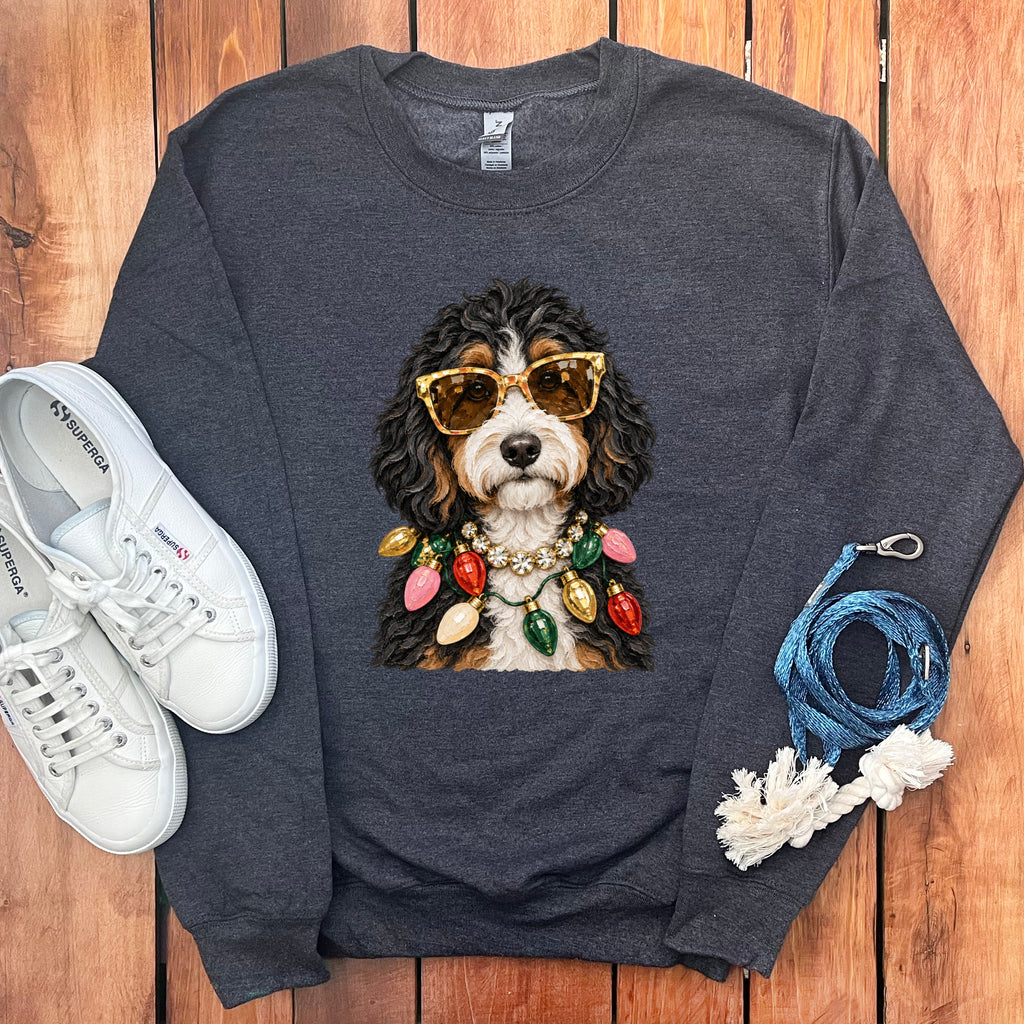 Dark grey sweatshirt with a Bernese Mountain Dog wearing sunglasses and a Christmas light necklace.