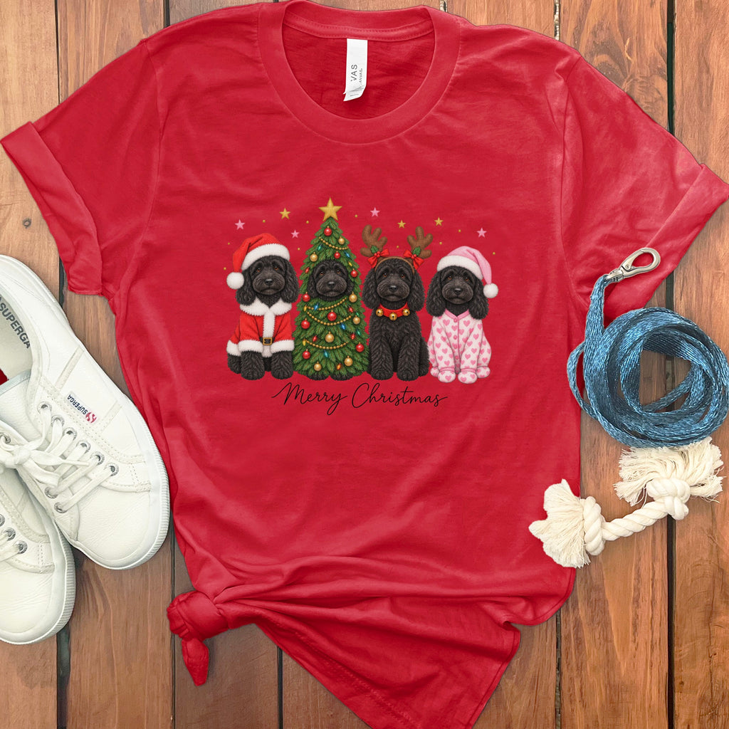 Red t-shirt featuring four black dogs in holiday costumes beside a Christmas tree and Merry Christmas text.