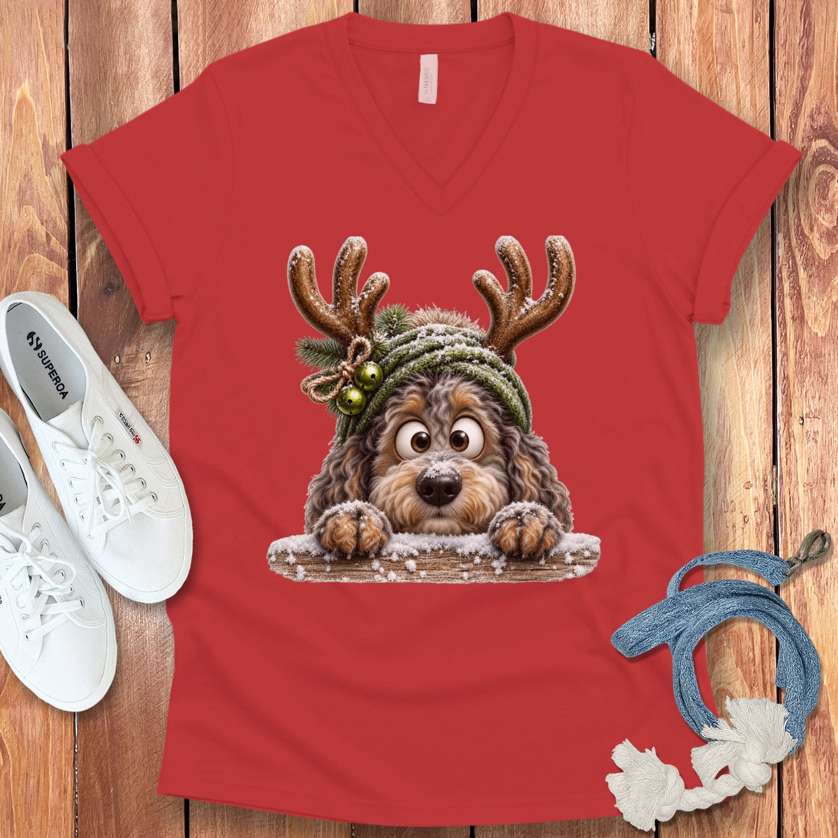 Red v-neck t-shirt with a cartoon dog wearing reindeer antlers and a hat.