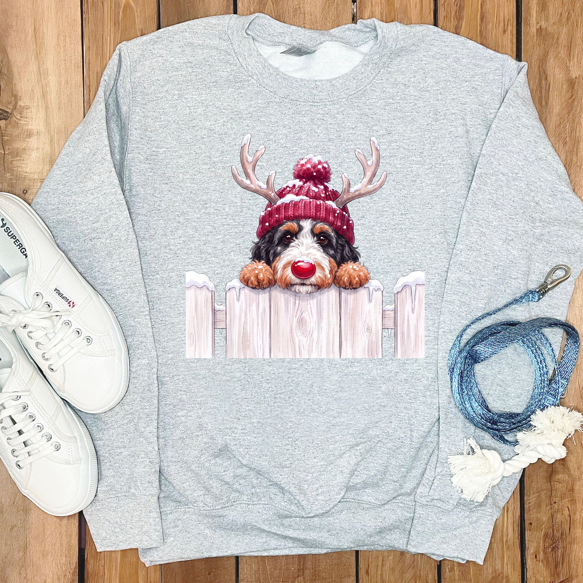 Gray sweatshirt with Bernese Mountain Dog wearing Christmas hat and reindeer antlers.