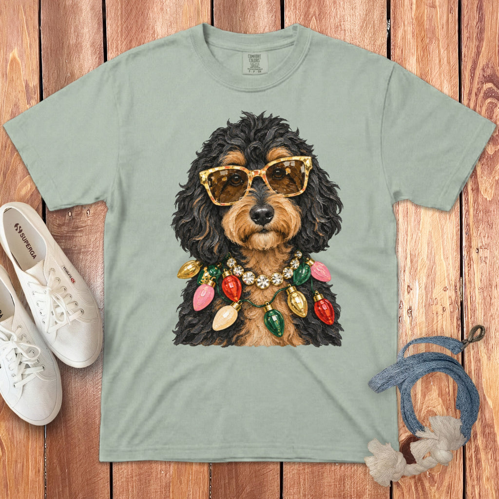 Light green t-shirt with graphic of dog wearing sunglasses and Christmas lights necklace.