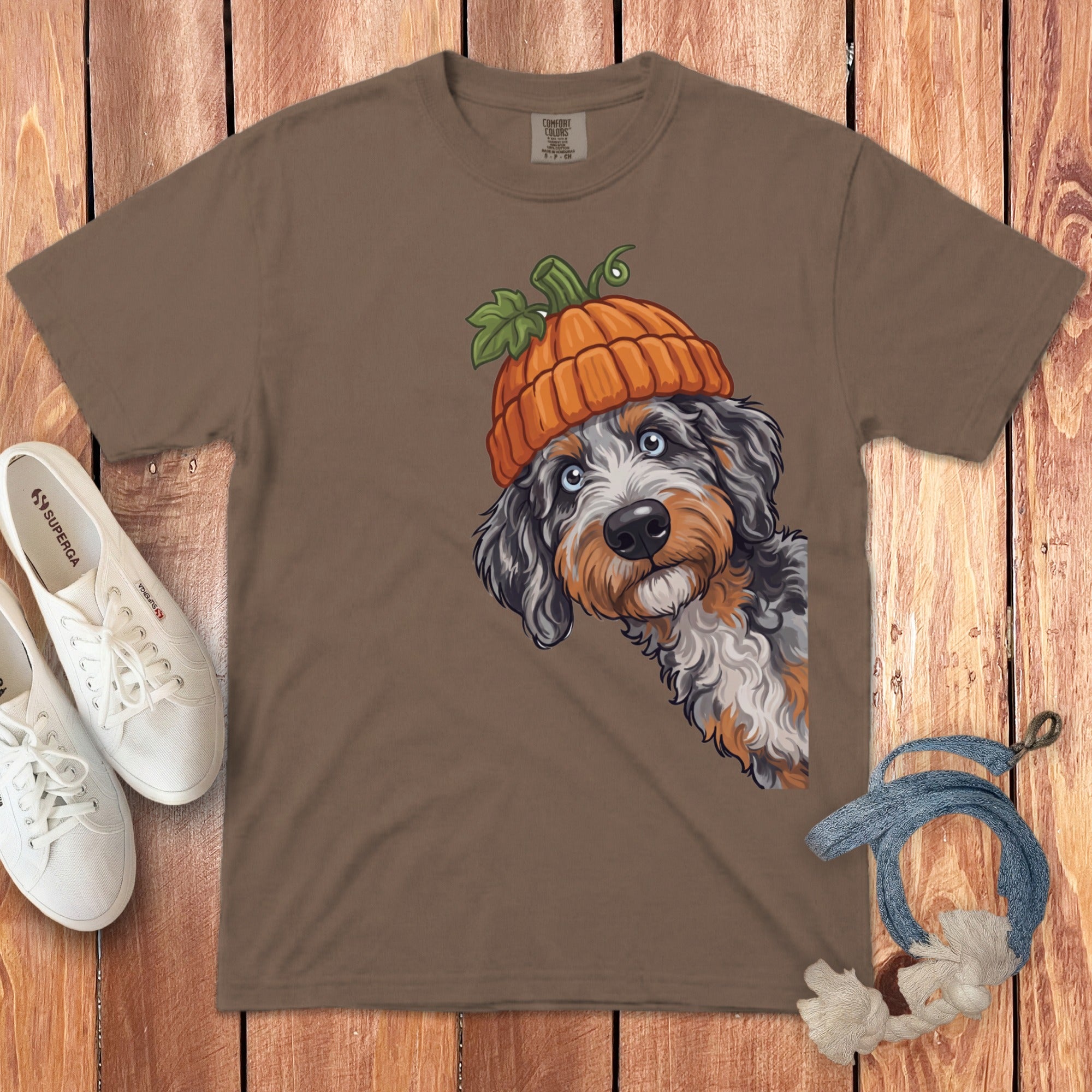 T-shirt with a Bernese Mountain Dog wearing a pumpkin hat and black and white sneakers.