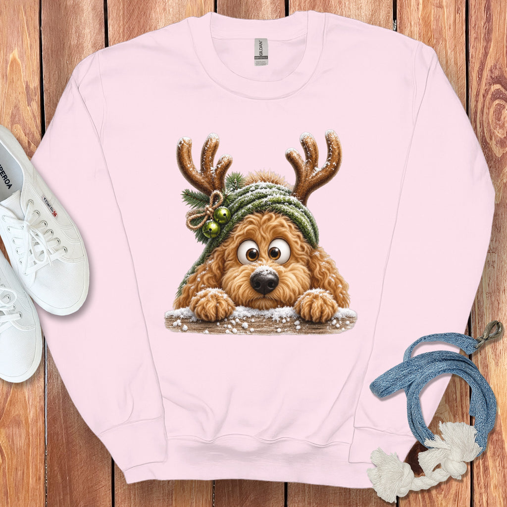 Pink crewneck sweatshirt with a cartoon dog wearing reindeer antlers and a green hat.