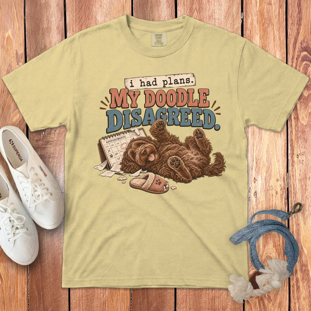 A yellow t-shirt with a graphic of a doodle dog, calendar, slipper, and text.