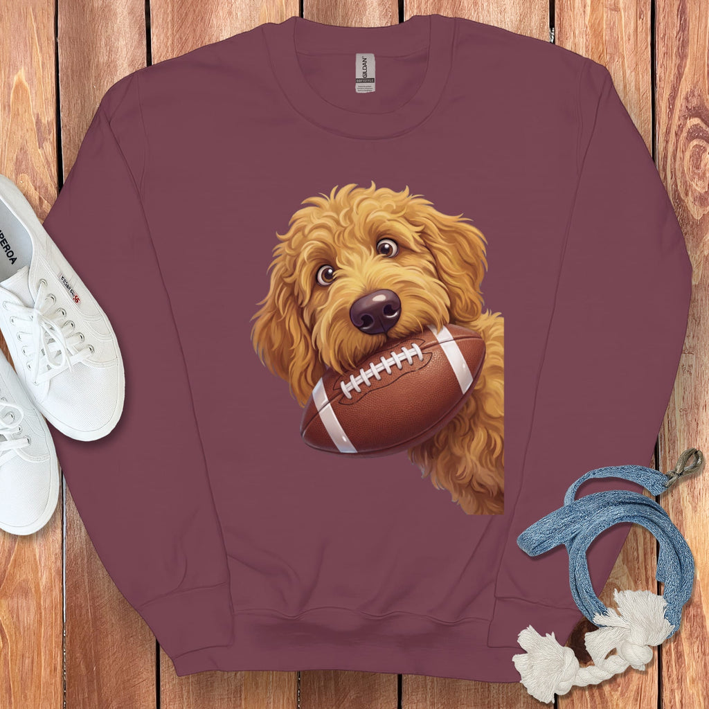 Maroon sweatshirt with a Goldendoodle holding a football graphic.