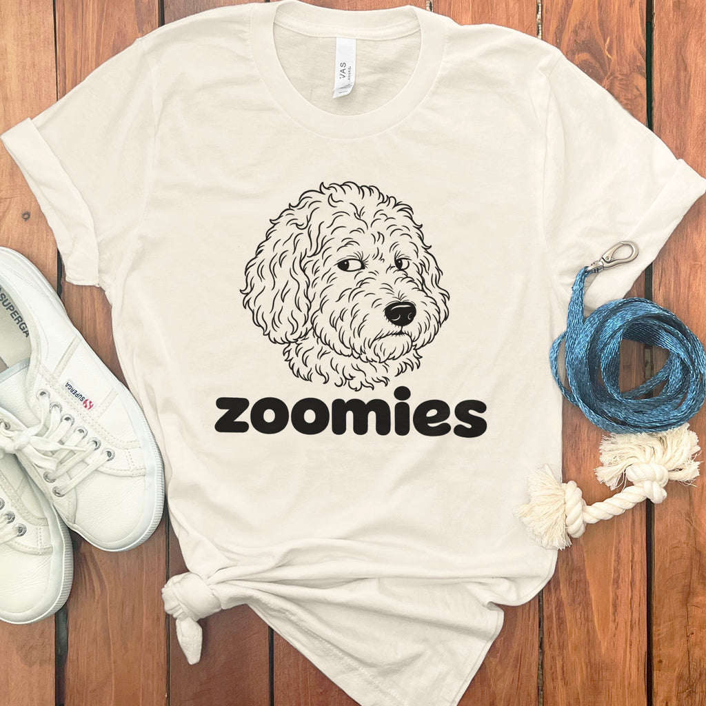 Cream t-shirt with a line drawing of a doodle dog and the word "zoomies".